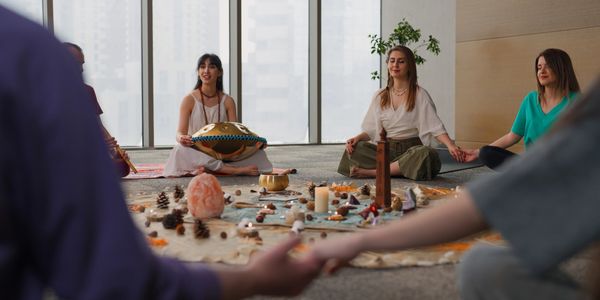 Group meditation with musical instruments and nature elements in a serene room.