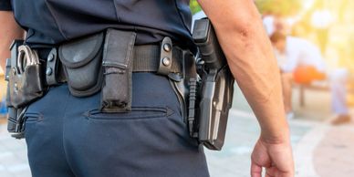 Close-up of a police officer's utility belt with equipment.