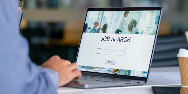 Person using laptop for job search online.