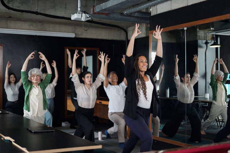 Group of multi-ethnic business people practicing office yoga and health exercise class in a modern office during work hours.