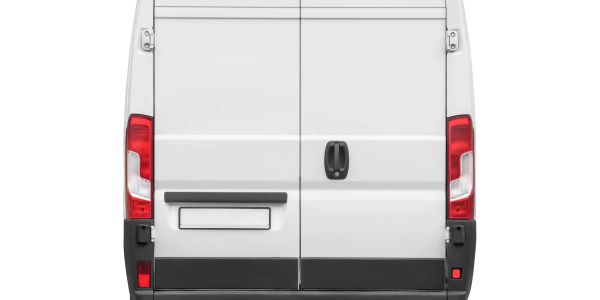 Rear view of a white cargo van with closed doors.