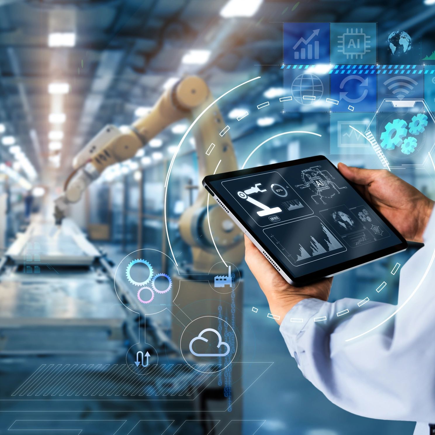 Technician using a tablet beside robotic equipment in an automated industrial facility.