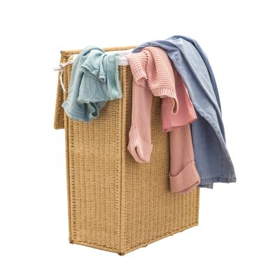 Wicker laundry basket with clothes hanging over the sides.