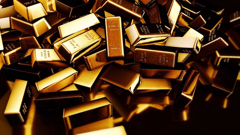 Gold bars fall on black background