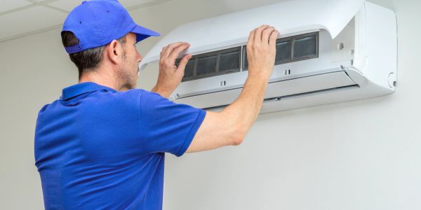 Technician inspecting an air conditioner.