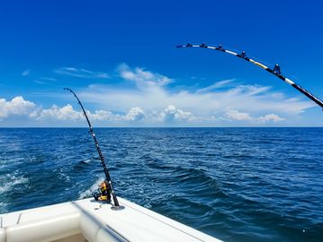 Fishing rods on a boat in the ocean.
