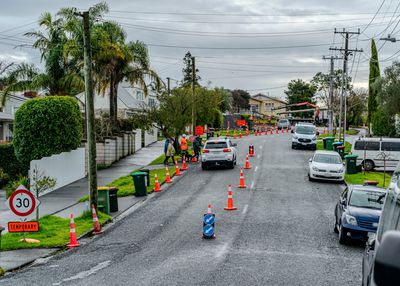 Temporary 30 km/h speed limit with roadwork and traffic cones on a suburban street.