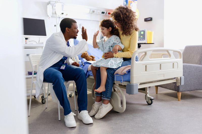 Caring pediatrician doing a medical examination with his little patient