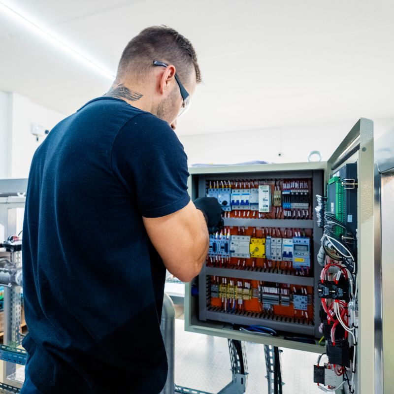 Photo of a man assembling a machine.
