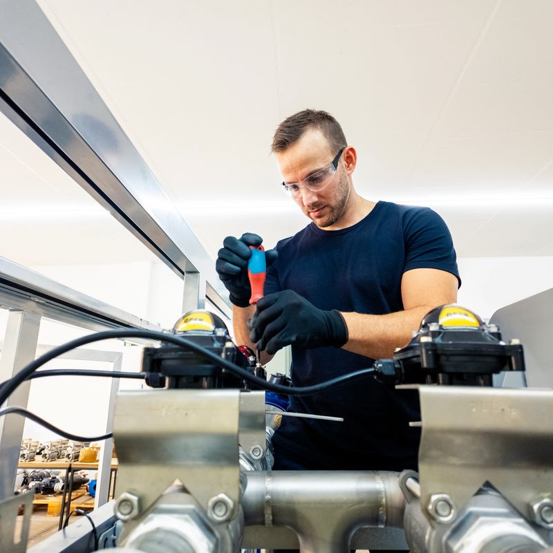 Photo of a man assembling a machine.