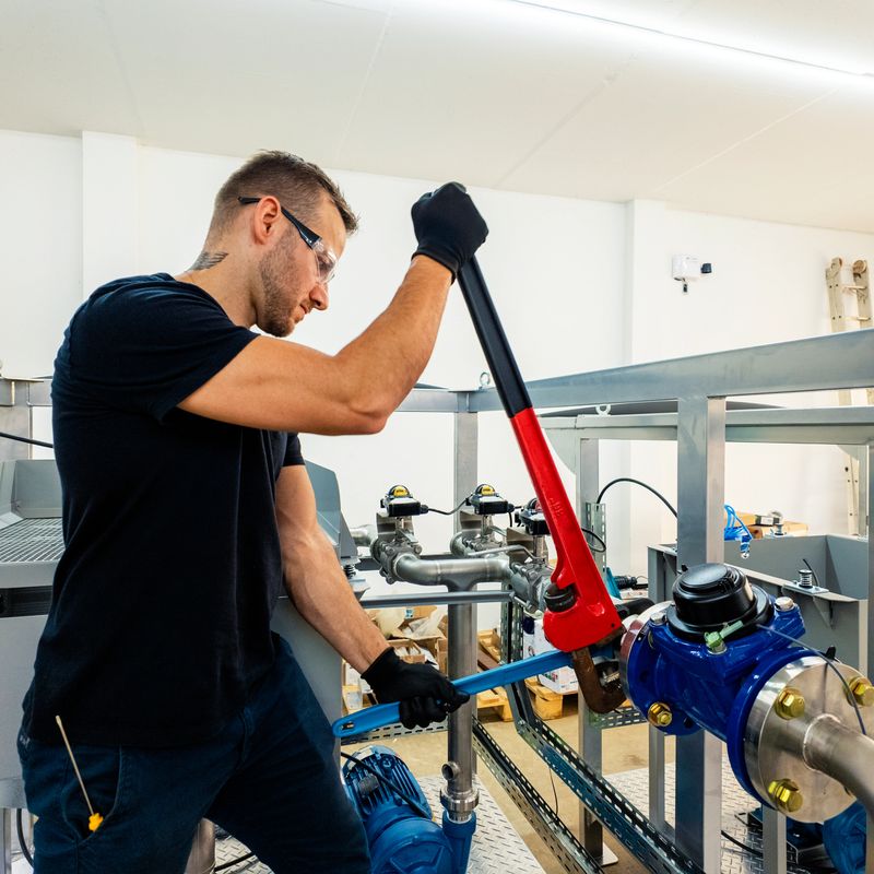 Photo of a man assembling a machine.