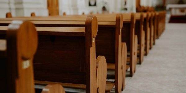 Empty wooden pews in a church.