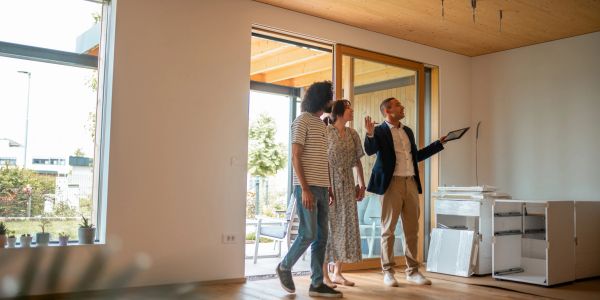 Real estate agent showing a house to a couple.
