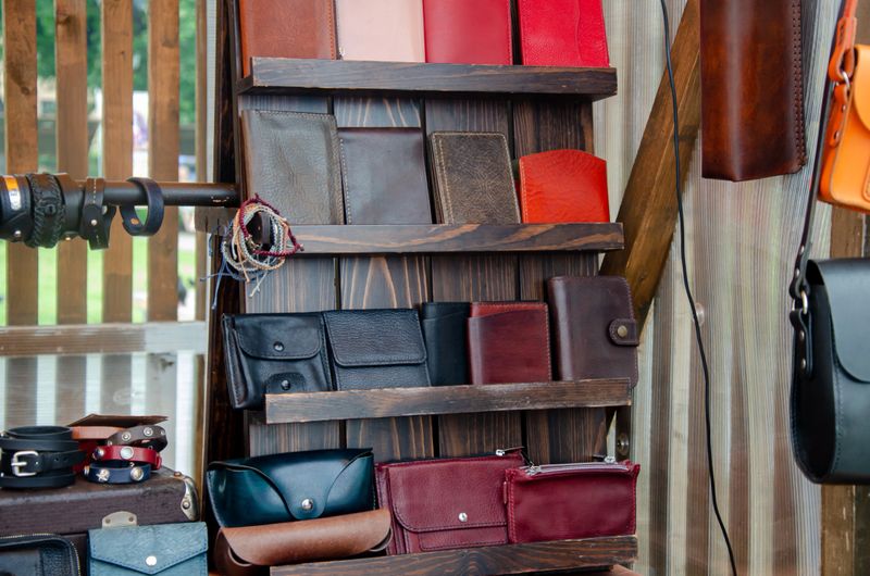 Designer handmade leather goods lie on the shelves