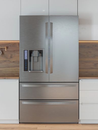 Modern stainless steel refrigerator with water and ice dispenser in a sleek kitchen.