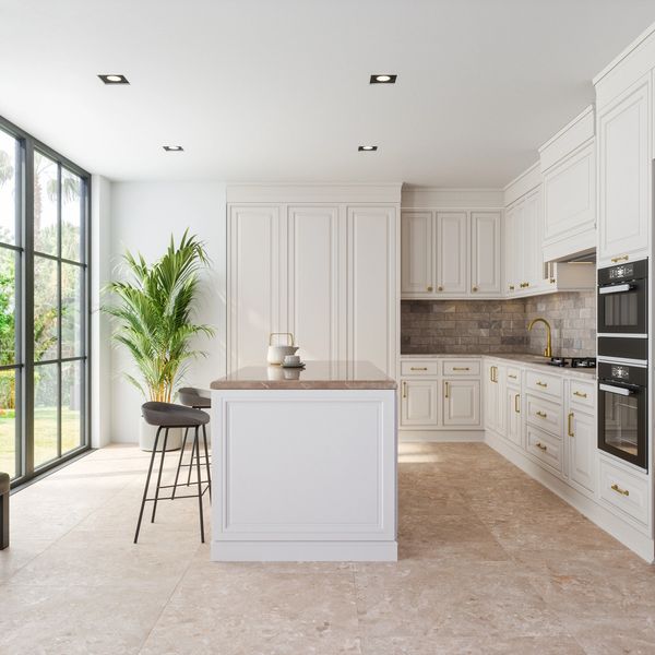 Bright modern kitchen with white cabinetry and large windows.