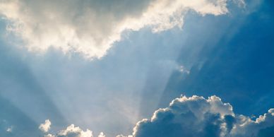 Acoming  light coming Sun rays from behind the clouds 