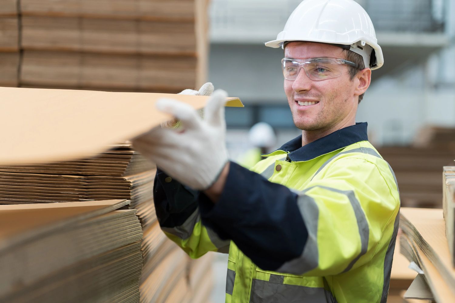Stack of books next to pencils in a holder and a camera.