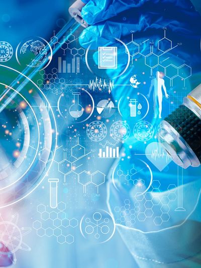 Scientist working with digital medical and chemical data overlays in a lab.