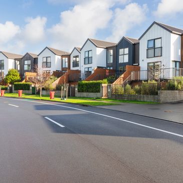 A row of modern townhouses on a sunny day.