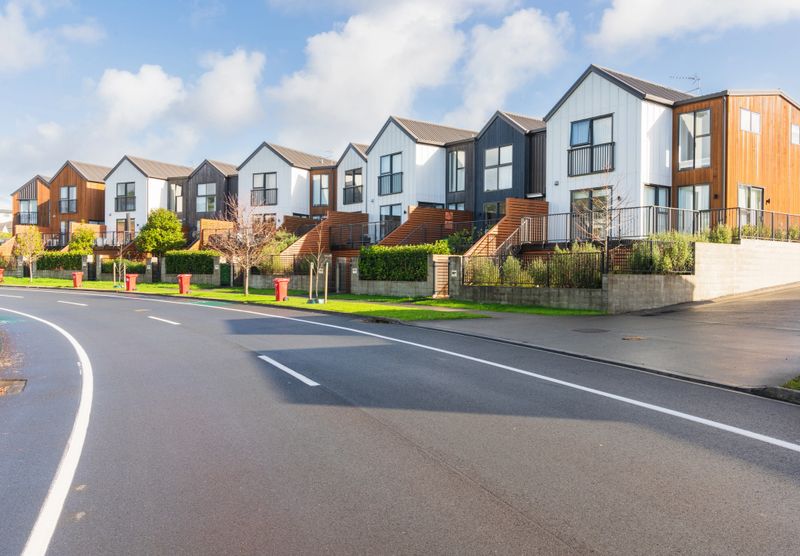 City street with road markings at residential area along with the suburb row houses.