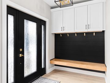 Functional mudroom with built-in storage bench and durable flooring designed for easy cleaning.