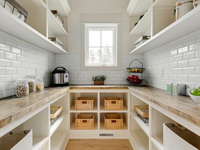 Bright, organized pantry with wooden countertops and wicker baskets.