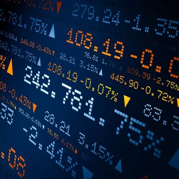 Digital stock market display with percentages and arrows showing market trends.
