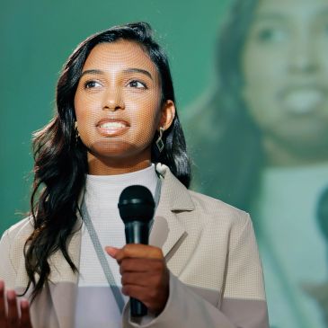 Young woman speaking with a microphone.