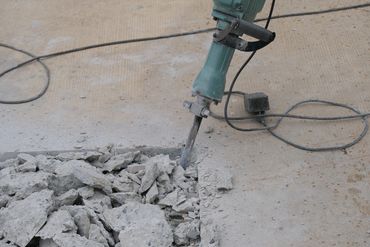 digging up concrete for piers