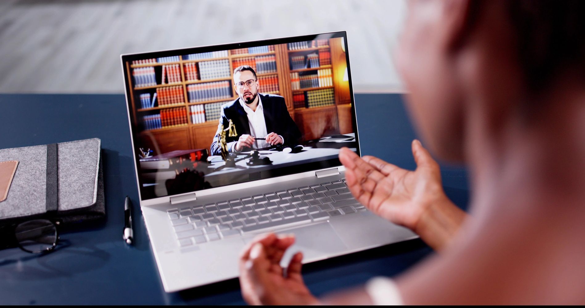 Person video calls a lawyer in a virtual consultation.