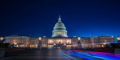The U.S. Capitol building illuminated at night.