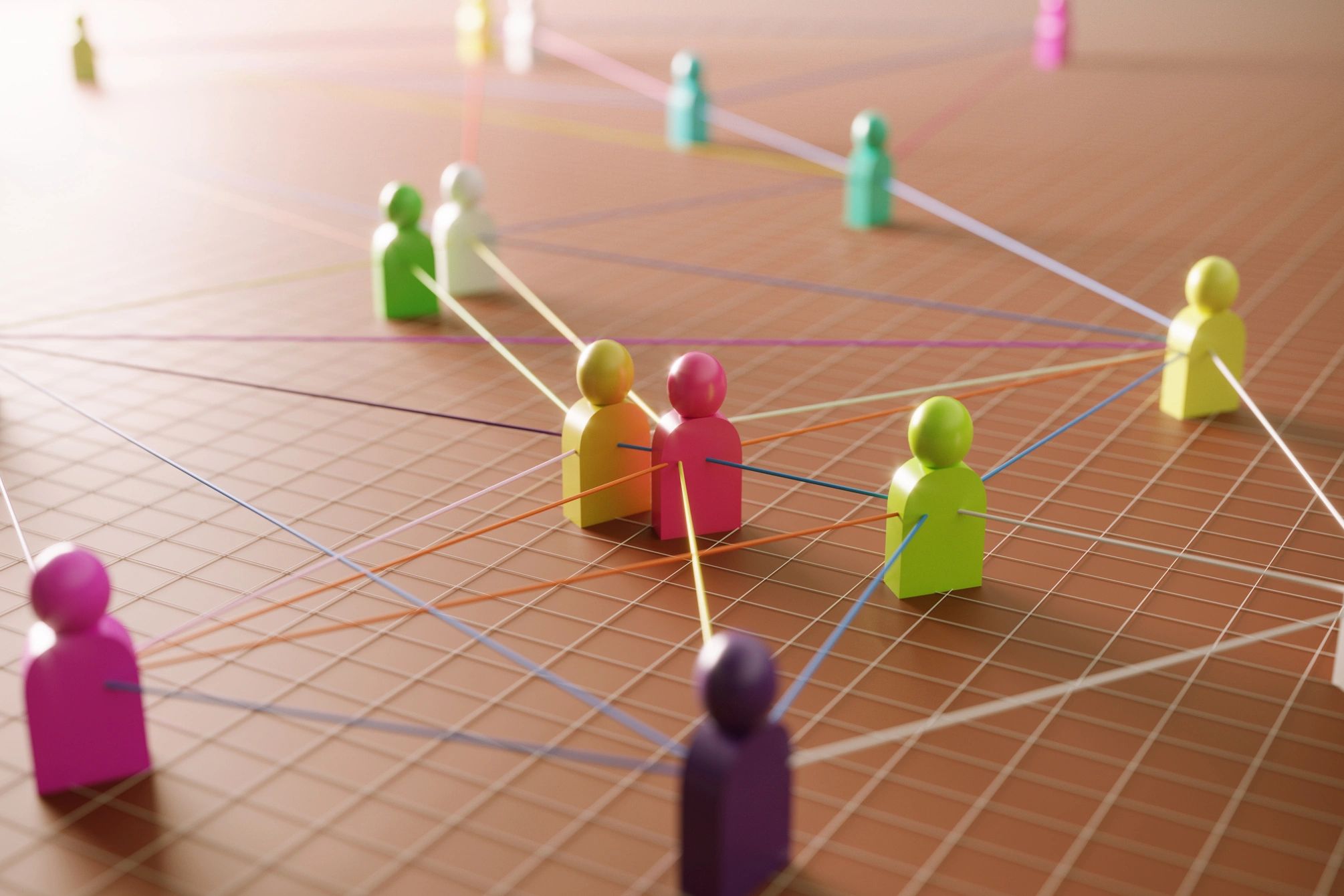 Colorful figurines connected by lines on a grid representing social networks.