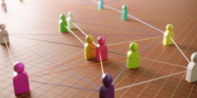 wooden people pieces connected by strings.