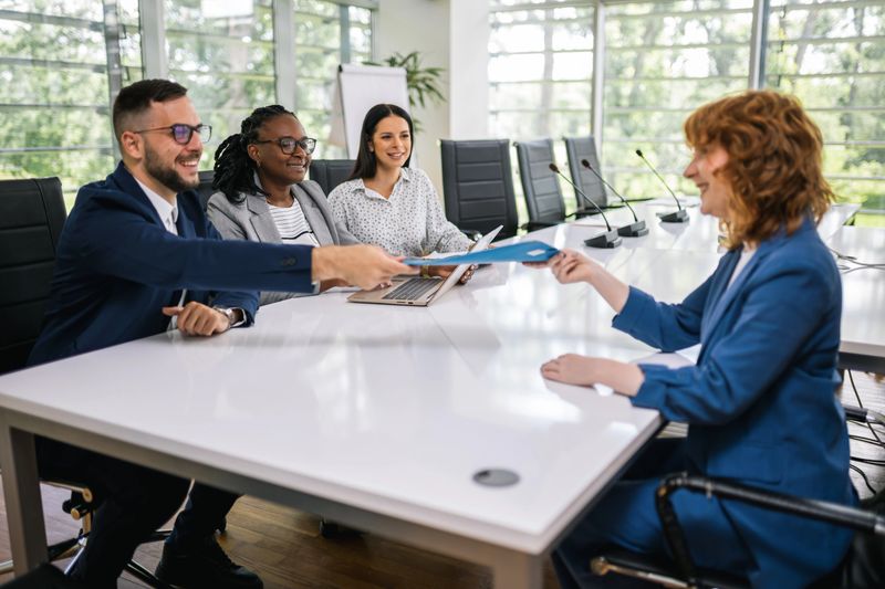 Human resource having a pleasant talk with a young female applicant in a relaxed atmosphere during an interview for a job.