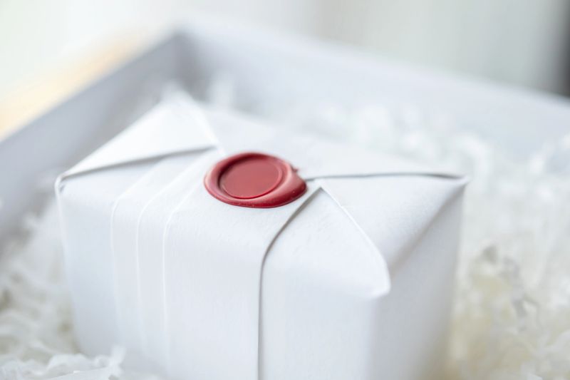 Wax seal stamp on white paper wrap packaging parcel box