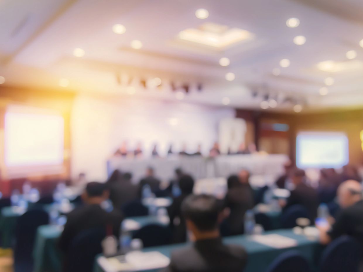 Corporate conference meeting room audience seated presentation stage business event
