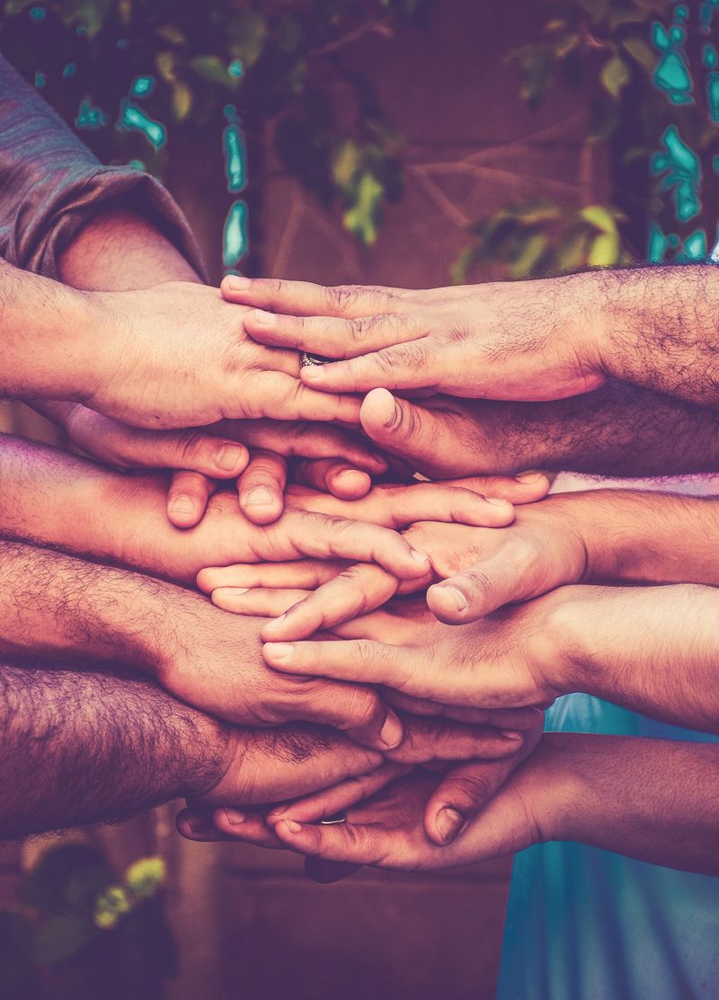 Cropped Image Of Friends Stacking Hands