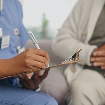 Doctor and patient writing notes