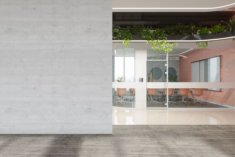 Modern Empty Office With Blank Wall, Meeting Table, Chairs And Creeper Plants