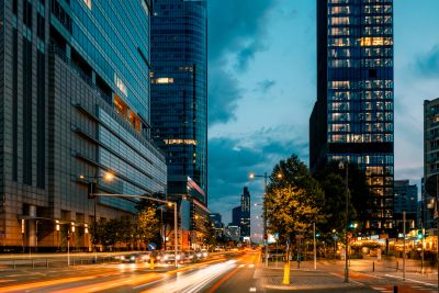 City street at dusk with light trails from cars.