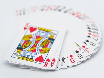 A fanned-out deck of playing cards with King and Ace of Hearts on top