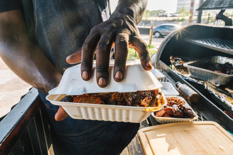 Black Entrepreneur Small Business Food Truck Owner Man Setting Up, Hosting, and Serving Customers in Downtown Houston, Texas, USA. 

Part of a Series, Photographed in Houston, Texas.