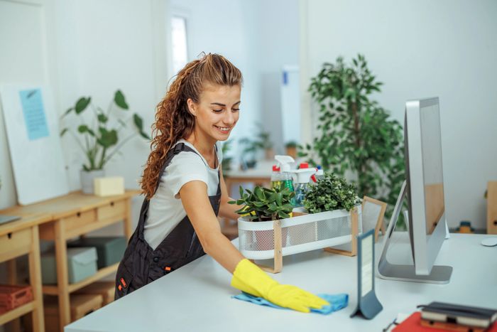 A cleaning cart with yellow bags and a mop