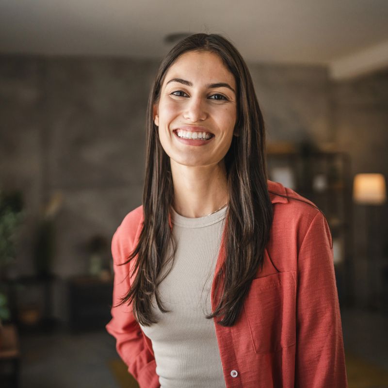 Portrait of beautiful adult young women stand and smile at home