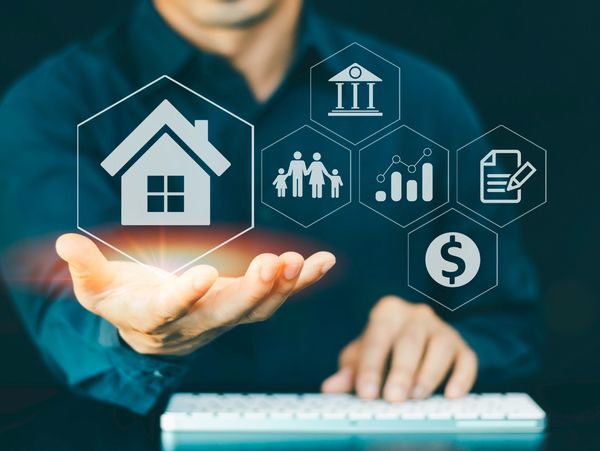 Person holding digital icons representing home, family, finance, and legal concepts.
