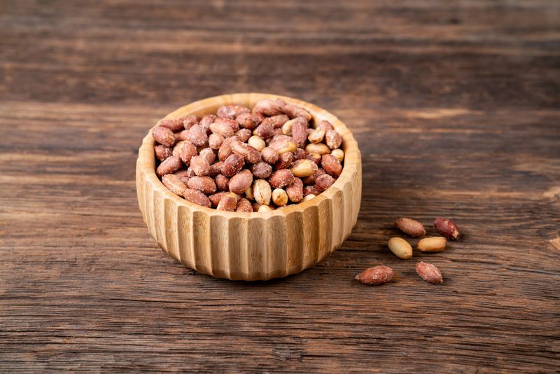 Roasted salty peanuts on the wooden table