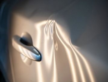 Minor collision dents on car door