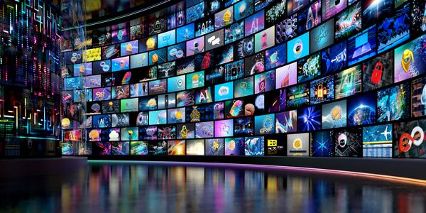 Curved digital wall filled with numerous colorful tech and AI images.