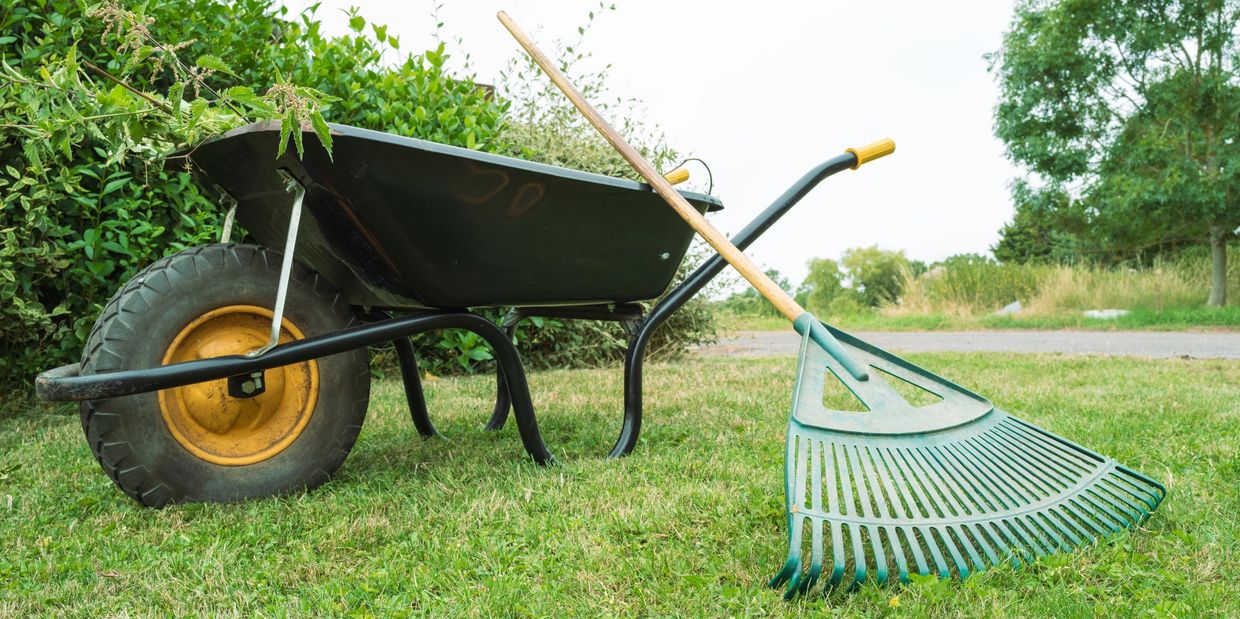 Wheelbarrow loaded with yard junk in Murrieta, BluCrew Landscape hauling green waste and debris.